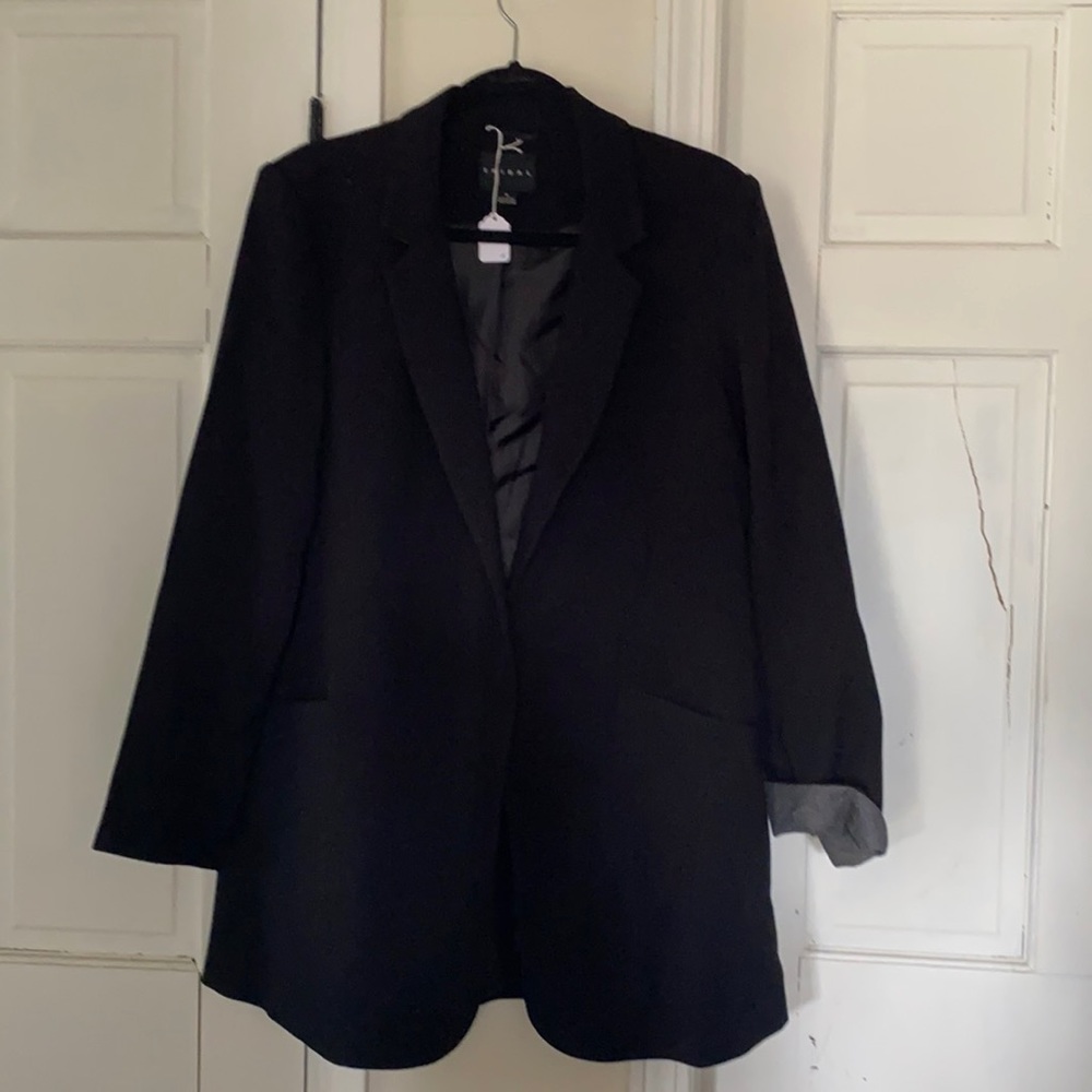 Black Blazer from Tribal. Sleeves w/a gray polyester inner trim. Size 12.